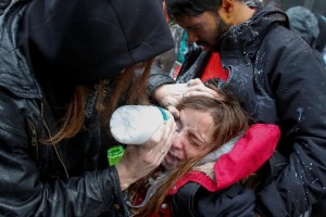 An activist demonstrating against President Trump is helped after being hit by pepper spray on the sidelines of the inauguration. REUTERS/Adrees Latif